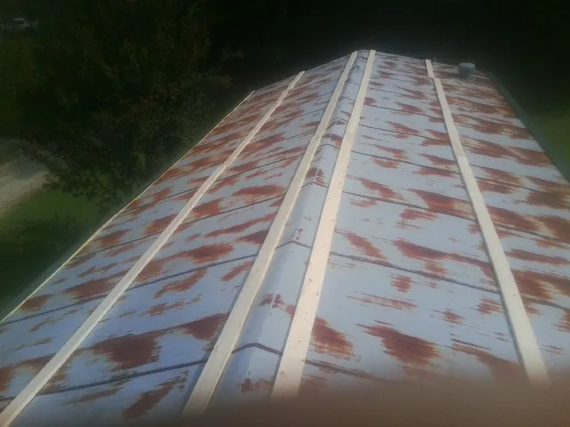 Rusted metal roof panels with new wood purlins before replacement — Storm Damage Roof Repair in Markleville by Roofing Brothers
